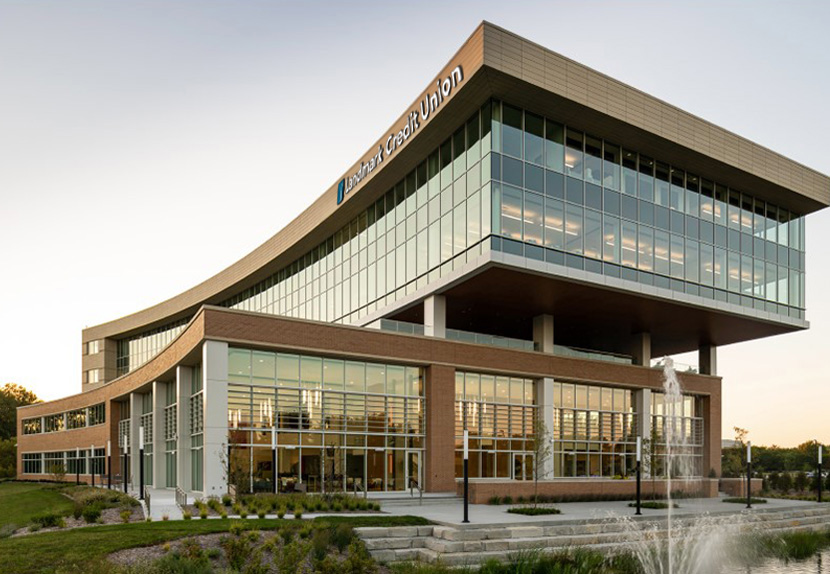 Landmark's corporate office building in Brookfield, WI, featuring glass sides and a fountain in the foreground. 