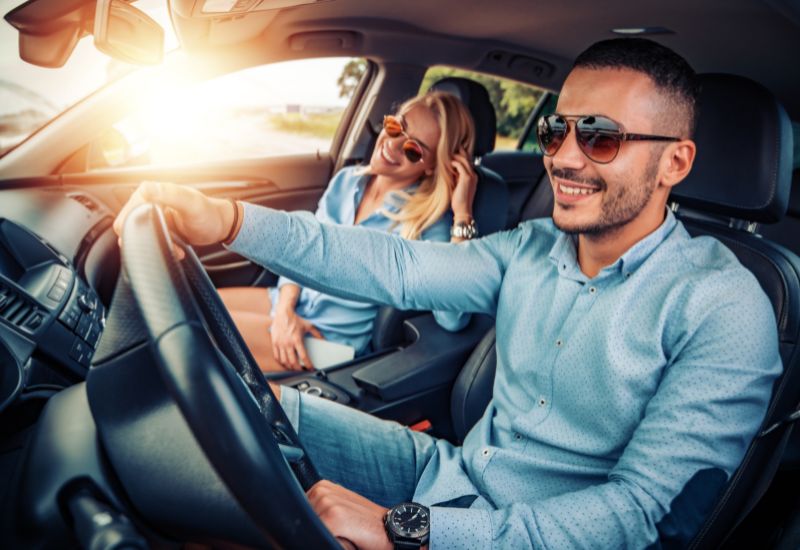 Smiling couple in a vehicle during the winter