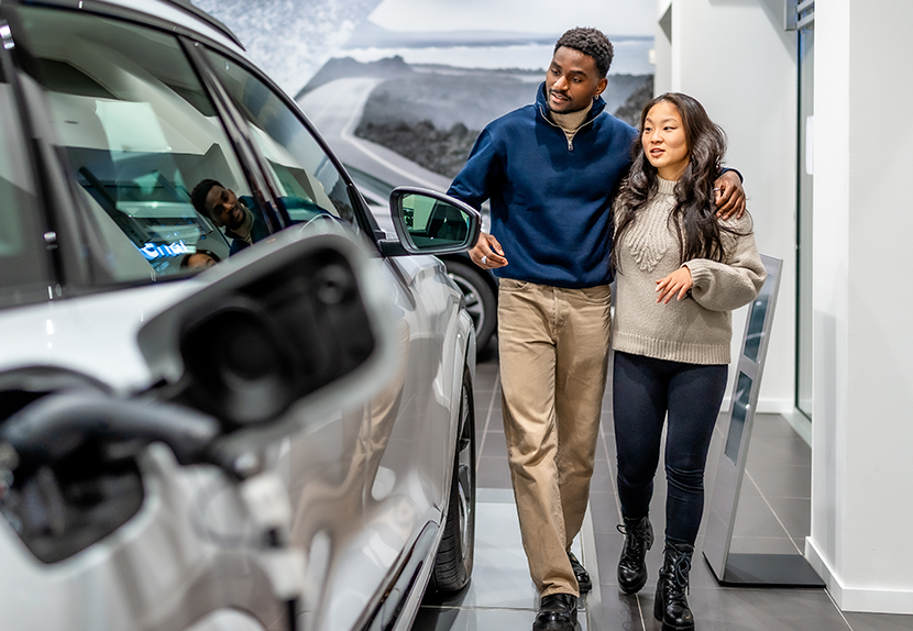 Couple looking at newer vehicle