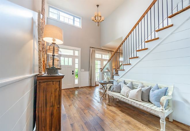 Home entryway with staircase and chandelier