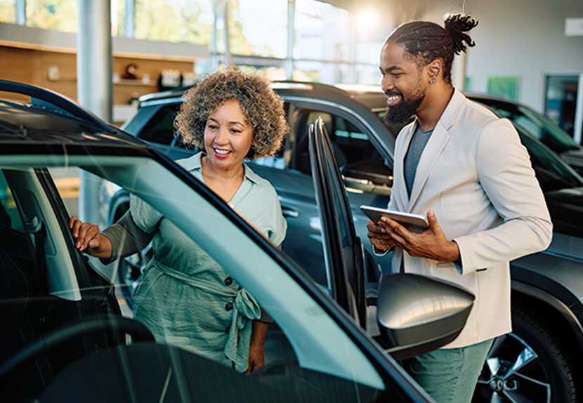 Couple shopping for car in a showroom