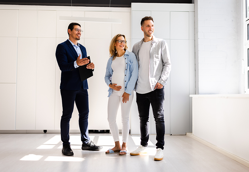 Couple touring a new home with a realtor