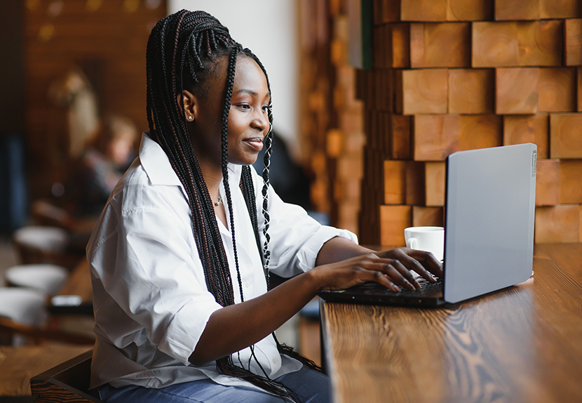Woman sitting in a cafe looking at her laptop