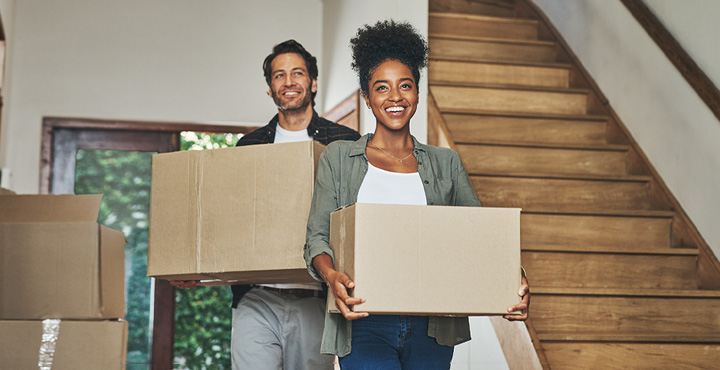 A newly settled couple in their home are making sure they are diligently organizes their paperwork.