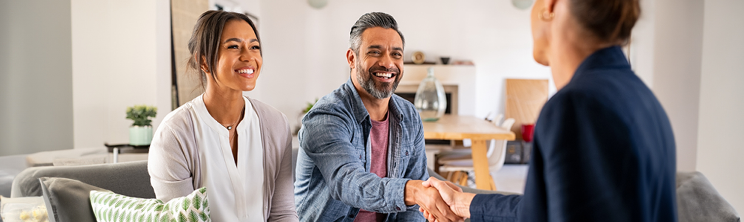A couple wears smiles of anticipation as they are eager to begin considering the various expenses associated with homeownership.