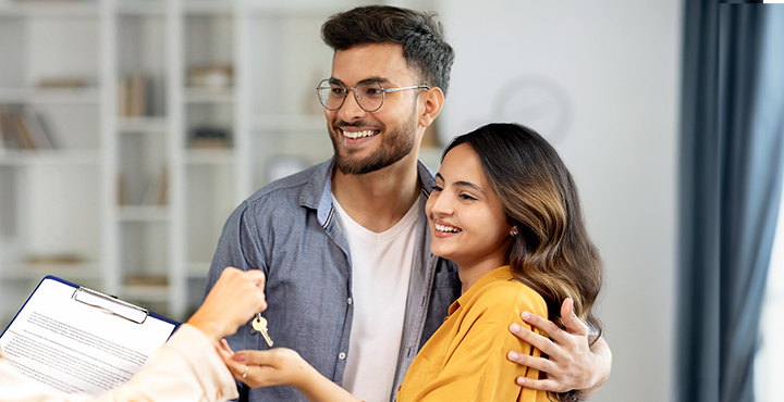 A couple are with a financial adviser regarding what is a down payment and ways to save.