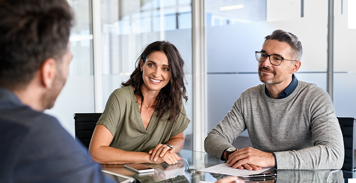 Couple talking to loan officer