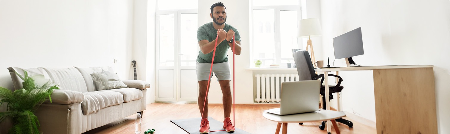 A member is at home doing on exercises in their living room.