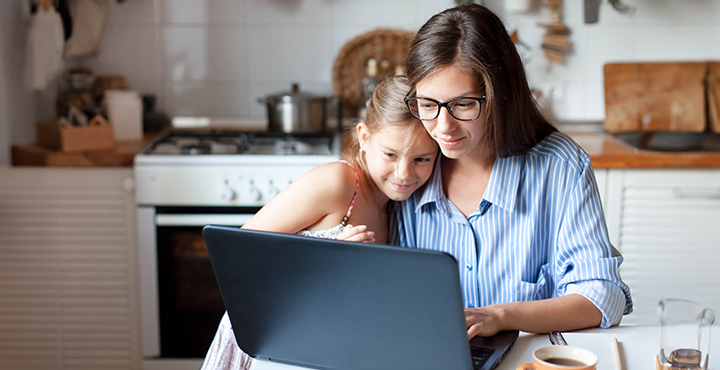 A single mother is with her daughter, searching for budget-friendly tips.