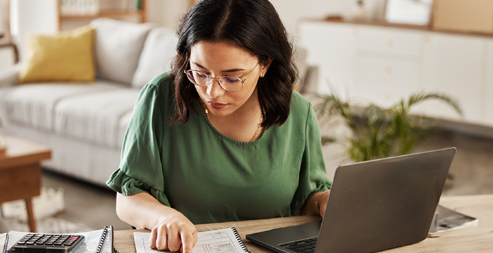 Person reviewing budget and planning for rising costs.