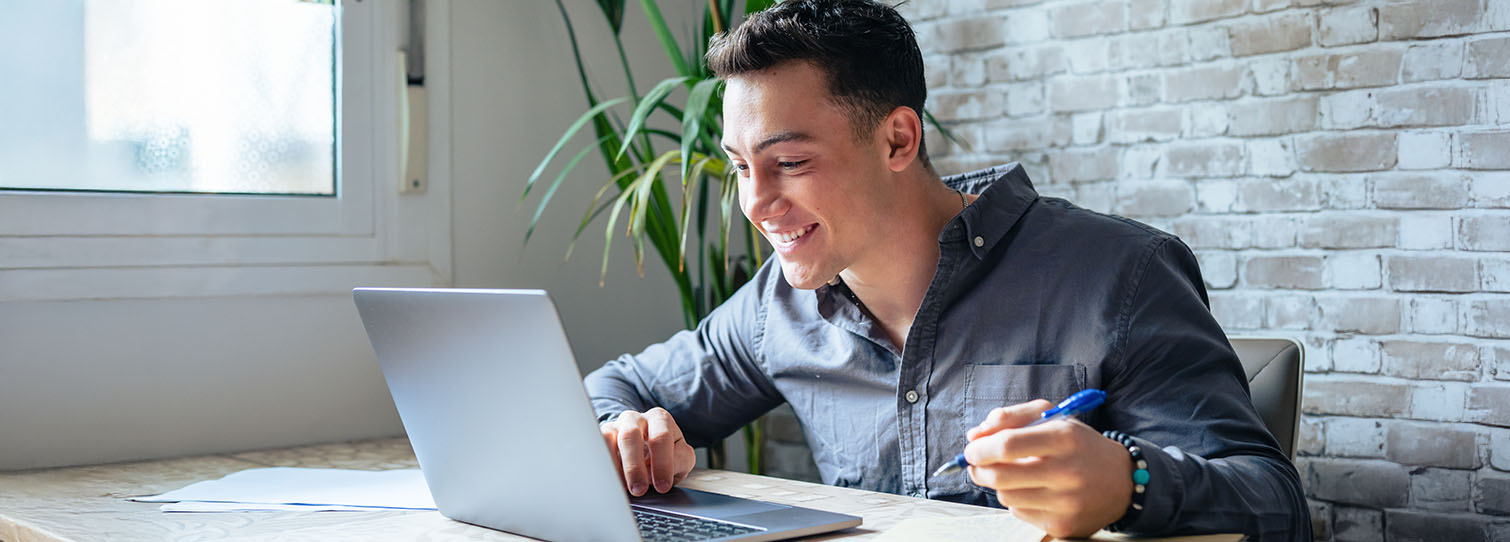 man looking at his laptop